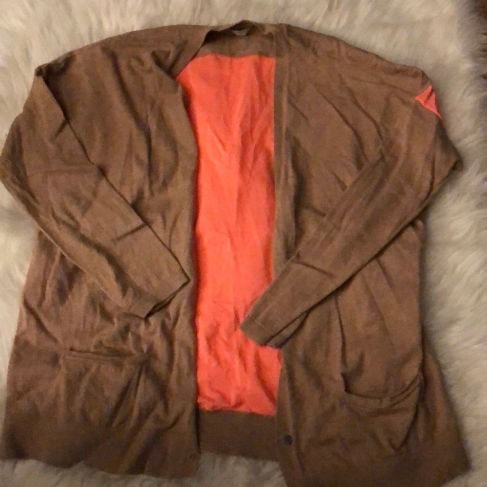 A pink and tan large sweater